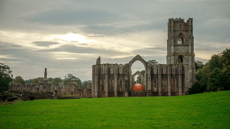 Helios peeks through the East Window of the ruins of Fountains Abbey